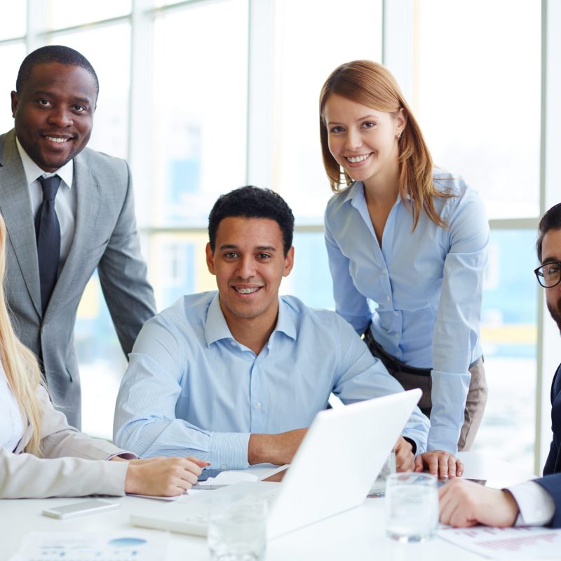 Business company Company of five employees sitting at workplace in office